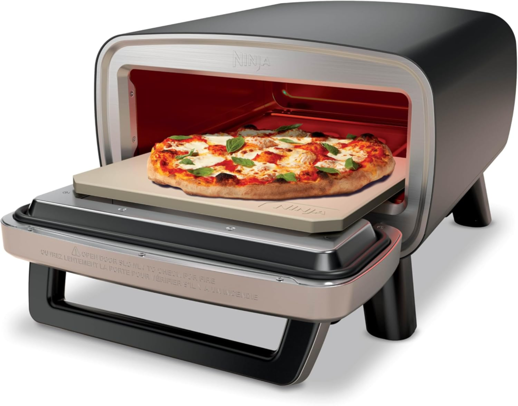 Ninja Artisan Outdoor Pizza Oven with a pizza cooking inside, showcasing its stylish design and features.